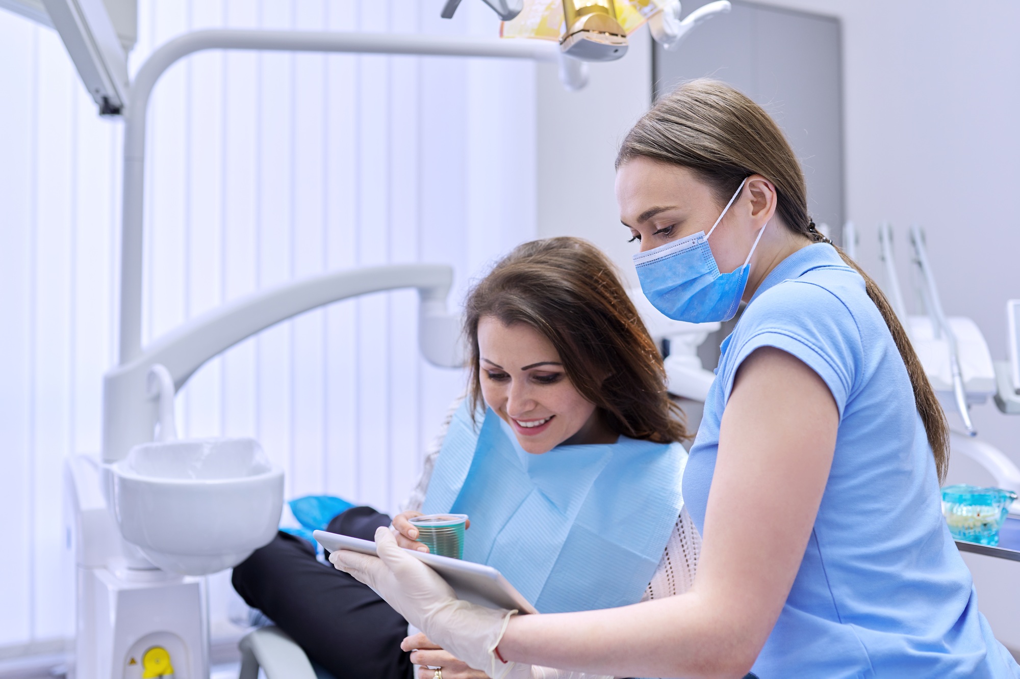 Dentistry, dental treatment, woman doctor dentist consults patient in chair